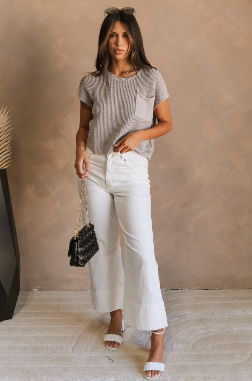 Full body view of female model wearing the Harper Grey Knit Short Sleeve Top which features Grey Small Cable Knit Fabric, Left Front Chest Pocket, Round Neckline and Short Sleeves