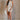 Full body view of female model wearing the Elodie Beige Ruffle Tier Sleeveless Romper which features Beige Lightweight Fabric, Beige Lining, Ruffle Tier Details, Round Neckline, Sleeveless and Back Button Closure