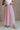 Front view of female model wearing the Adele Dusty Pink Pleated Tulle Midi Skirt which features Dusty Pink Tulle Pleated Fabric, Dusty Pink Lining, Midi Length and Satin Elastic Band