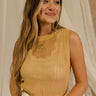 Front view of model wearing the Heidi Mustard Open Knit Tank which has a round neckline, open knit fabric, and sleeveless body. Layered over white tank top.
