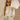 Front view of female model wearing the Kimberly Cream Pleated Long Sleeve Top which features Cream Sheer Plisse Fabric, Cropped Waist, Lettuce Hem Details, Round Neckline and Open Back with Tie Closures