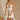 Front view of model wearing the Rosalind Cream & Black Sheer Mini Skirt, which has lined cream sheer fabric, black ruffle and tie details, and an elastic waist. Paired with matching top.