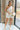 Full body view of female model wearing the Celeste Cream Textured One-Shoulder Romper which features Cream Textured Fabric, Cream Lining, One-Shoulder Strap and Sleeveless
