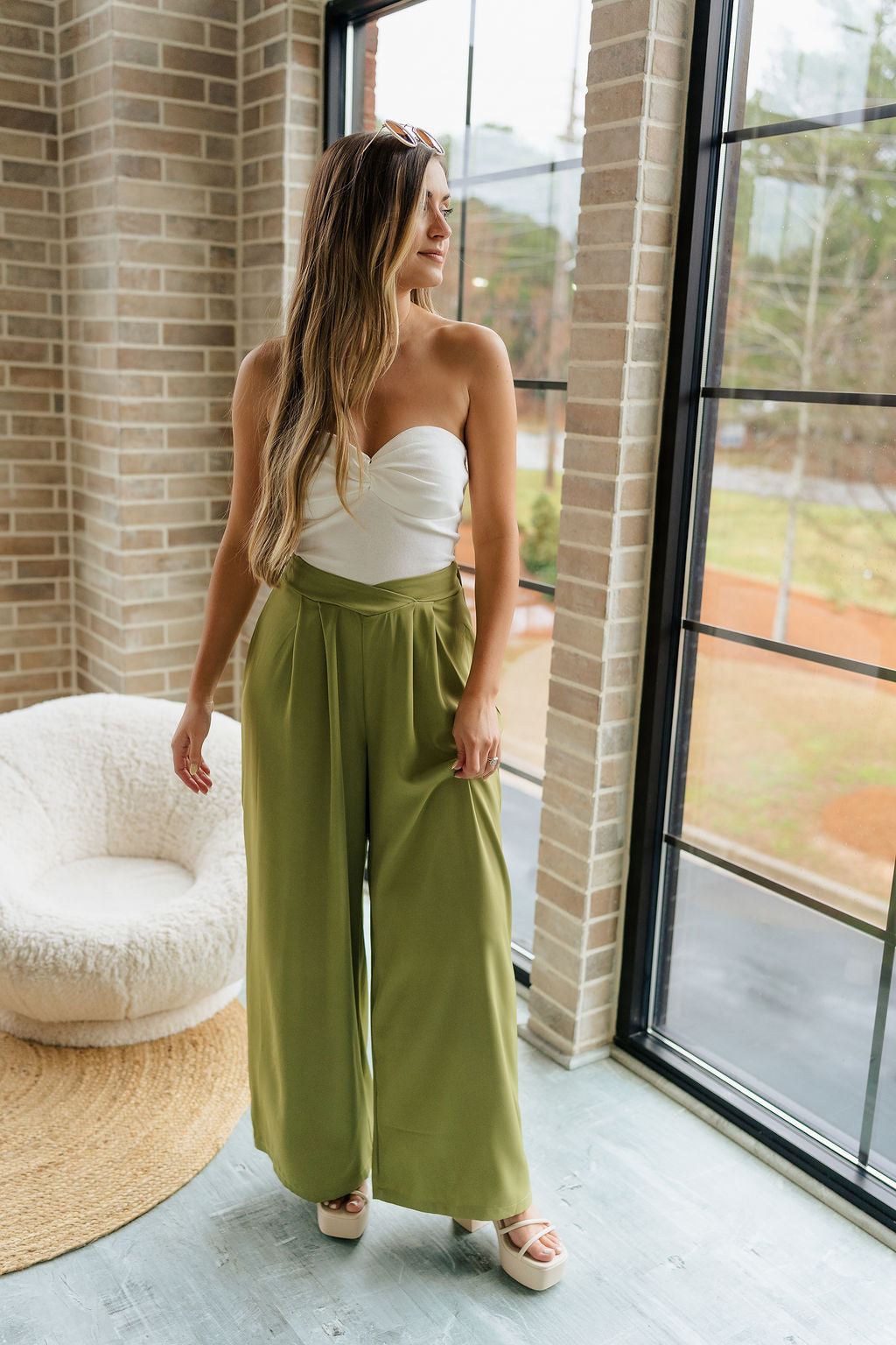 Full body view of female model wearing the Rowan Olive Wide Leg Pants which features Olive Green Lightweight Fabric, Wide Pant Leg and Elastic V- Waistband