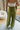 Back view of female model wearing the Rowan Olive Wide Leg Pants which features Olive Green Lightweight Fabric, Wide Pant Leg and Elastic V- Waistband