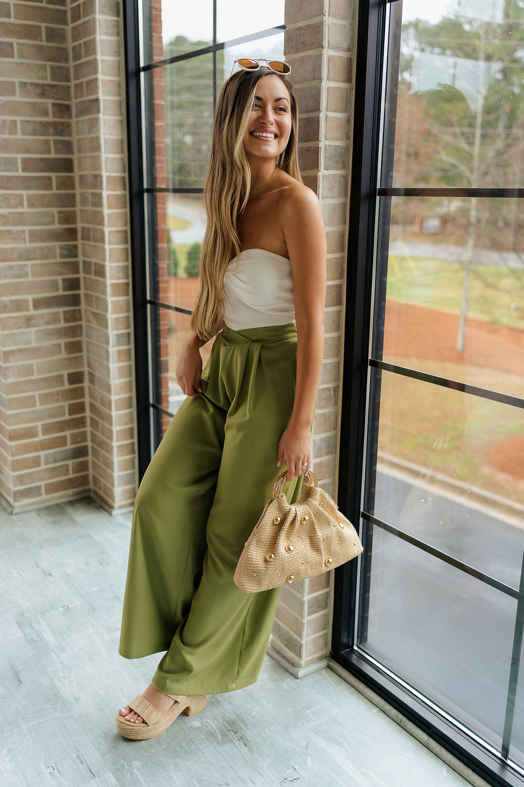 Full body view of female model wearing the Rowan Olive Wide Leg Pants which features Olive Green Lightweight Fabric, Wide Pant Leg and Elastic V- Waistband
