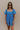 Front view of model wearing the Marissa Blue and White Floral Short Sleeve Romper which features Blue Lightweight Fabric, White Floral Design, Blue Lining, Square Neckline, Short Puff Sleeves and Smocked Back.