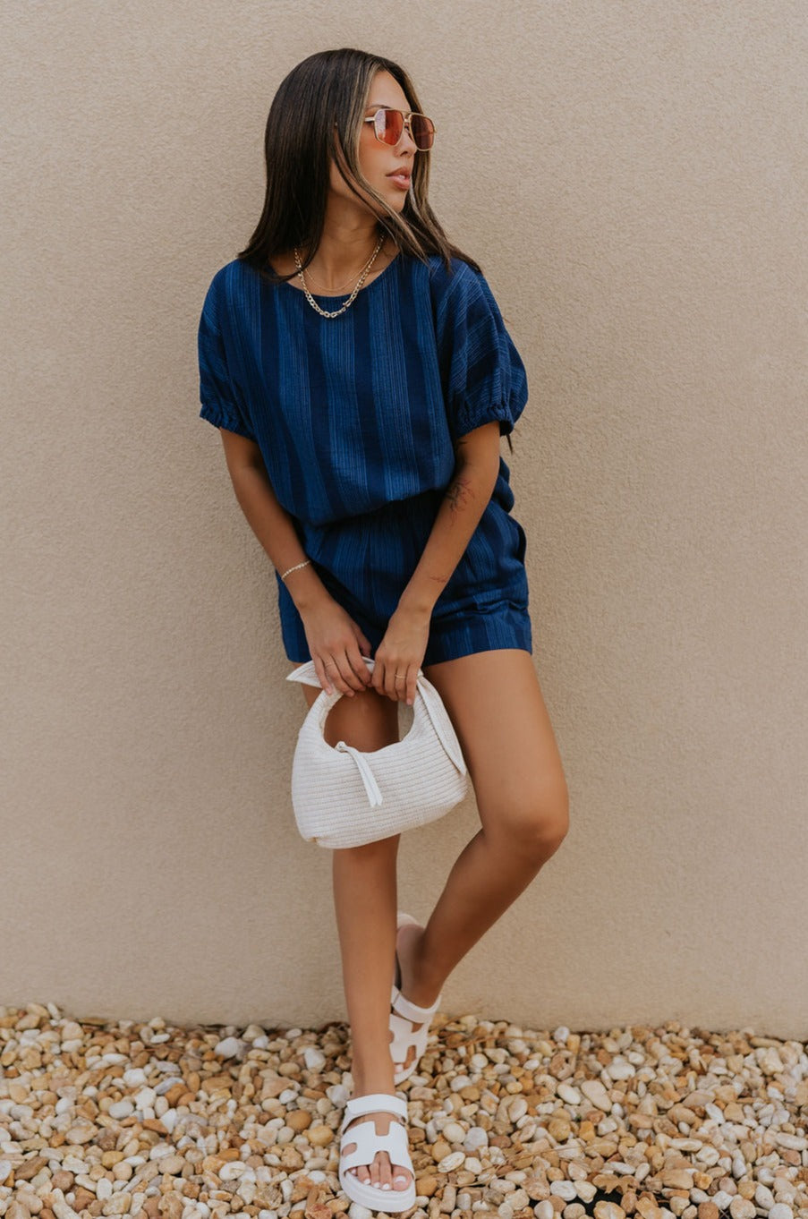 Full body view of female model wearing the Julissa Navy Stripe Short Sleeve Top which features Navy Blue with Light Blue Stripe Design, Round Neckline and Short Sleeves