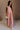 Full body view of female model wearing the Brooklyn Sleeveless Wide Leg Jumpsuit in salmon pink which features Wide Pant Legs, Two Front Pockets, Lined Pant Legs, Round Neckline and Sleeveless.