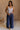 FUll body view of female model wearing the Olivia Navy Blue Smocked Pants which features Navy Knit Fabric, Wide Pant Legs, Navy Lining and Smocked Waistband