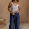 FUll body view of female model wearing the Olivia Navy Blue Smocked Pants which features Navy Knit Fabric, Wide Pant Legs, Navy Lining and Smocked Waistband