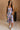 Full body view of female model wearing the Madison Blue and Rose Pink Midi Dress which features Blue and Pink Floral Design, Midi Length, Sweetheart Neckline and Adjustable Straps.