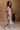 Full body side view of female model wearing the Madison Blue and Rose Pink Midi Dress which features Blue and Pink Floral Design, Midi Length, Sweetheart Neckline and Adjustable Straps.