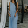 Full body view of female model wearing the Brooklyn Sleeveless Wide Leg Jumpsuit in light blue which features Wide Pant Legs, Two Front Pockets, Lined Pant Legs, Round Neckline and Sleeveless.