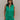 Front view of female model wearing the Serena Zip-Up Sleeveless Romper in Green which features Cotton Fabric, Two Front Pockets, Two Back Pockets, Front Zip-Up Closure, Collared Neckline and Sleeveless.