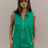 Front view of female model wearing the Serena Zip-Up Sleeveless Romper in Green which features Cotton Fabric, Two Front Pockets, Two Back Pockets, Front Zip-Up Closure, Collared Neckline and Sleeveless.