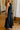 side view of the Chloe Black Pleated Flare Strapless Midi Dress