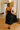 back view of the Chloe Black Pleated Flare Strapless Midi Dress