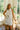 front view of the Posie White Eyelet Mini Dress