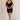Full body view of female model wearing the Sophia Black Plunge Neckline Mini Dress which features Black Lightweight Fabric, Mini Length, Side Ruched Detail with Covered Buttons Closure, Scoop Neckline, Adjustable Straps and Sleeveless