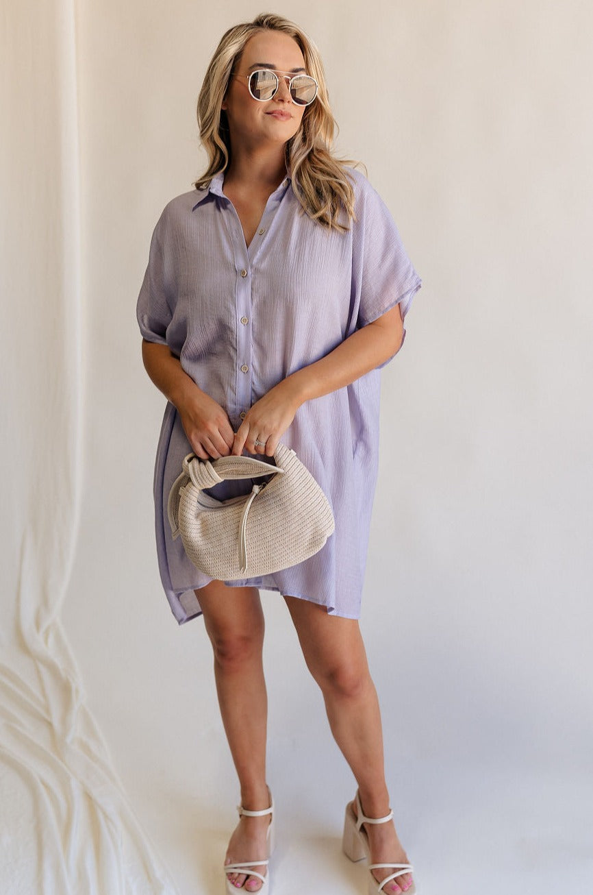Full body view of female model wearing the Luna Lavender Button-Up Short Sleeve Mini Dress which features Lavender Lightweight Fabric, Button-Up Front Closure, Collared Neckline and Short Sleeves