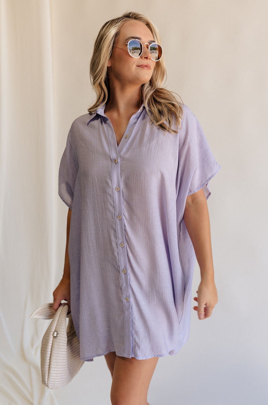 Front view of female model wearing the Luna Lavender Button-Up Short Sleeve Mini Dress which features Lavender Lightweight Fabric, Button-Up Front Closure, Collared Neckline and Short Sleeves