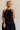 Front view of female model wearing the Luna Halter Tie Tiered Maxi Dress in black which features Lightweight Fabric, Tiered Body, Maxi Length, Thigh Length Lining, Halter Neckline with Tie and Open Back