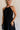 Front view of female model wearing the Luna Halter Tie Tiered Maxi Dress in black which features Lightweight Fabric, Tiered Body, Maxi Length, Thigh Length Lining, Halter Neckline with Tie and Open Back