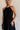 Front view of female model wearing the Luna Halter Tie Tiered Maxi Dress in black which features Lightweight Fabric, Tiered Body, Maxi Length, Thigh Length Lining, Halter Neckline with Tie and Open Back