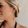 Side view of female model wearing the Ellie Gold Bow Dangle Earring which features gold bow shaped studs with back clasp closure