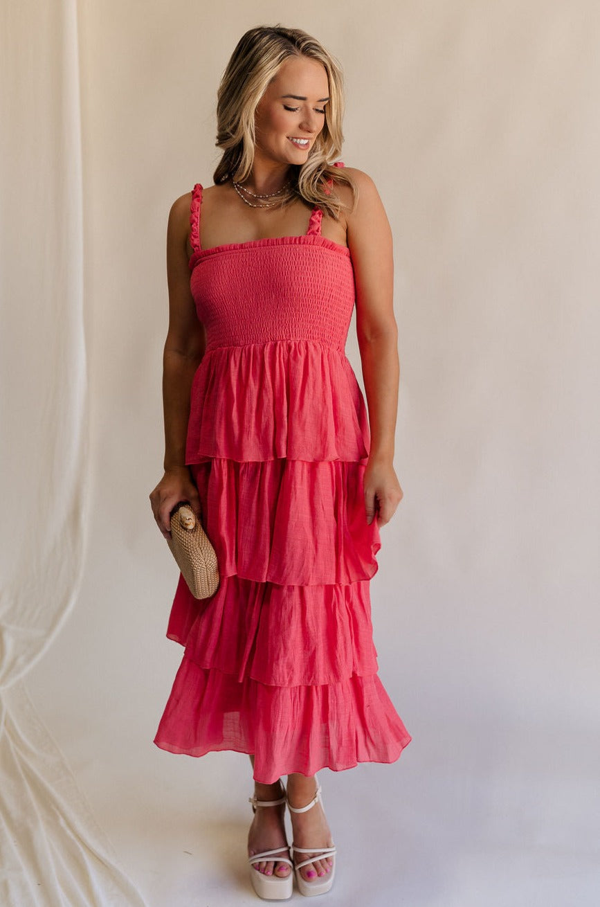 Full body view of female model wearing the Nova Smocked Tiered Midi Dress which features Lightweight Fabric, Fully Lined, Tiered Ruffle Body,  Smocked Upper, Square Neckline and Elastic Straps. 