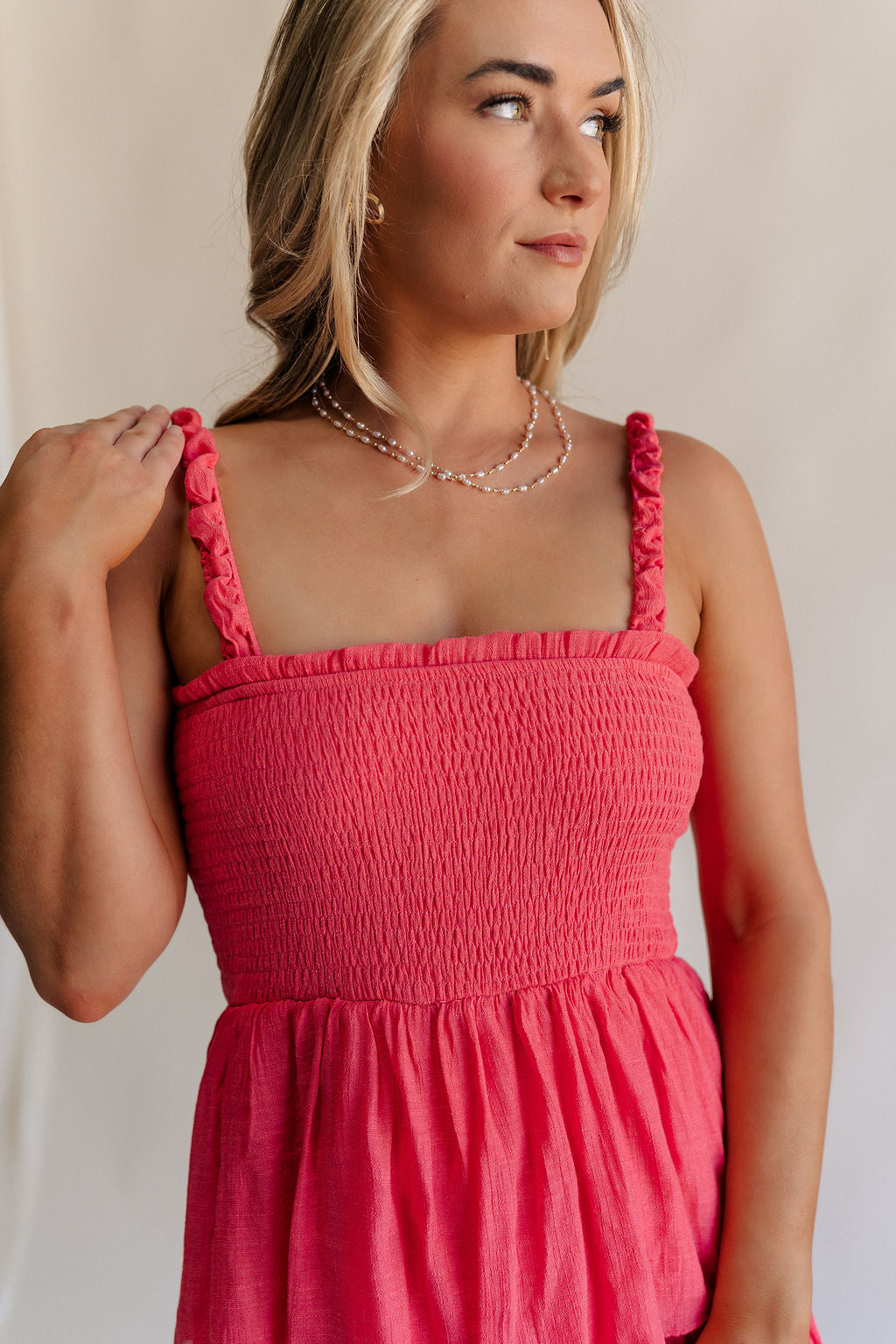 Close up view of female model wearing the Nova Smocked Tiered Midi Dress which features Lightweight Fabric, Fully Lined, Tiered Ruffle Body, Smocked Upper, Square Neckline and Elastic Straps.