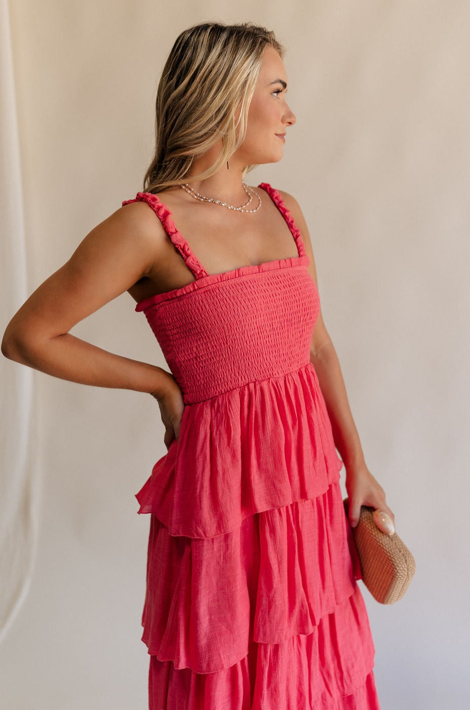 Side view of female model wearing the Nova Smocked Tiered Midi Dress which features Lightweight Fabric, Fully Lined, Tiered Ruffle Body, Smocked Upper, Square Neckline and Elastic Straps.