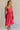 Full body side view of female model wearing the Nova Smocked Tiered Midi Dress which features Lightweight Fabric, Fully Lined, Tiered Ruffle Body, Smocked Upper, Square Neckline and Elastic Straps.