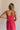 Back view of female model wearing the Nova Smocked Tiered Midi Dress which features Lightweight Fabric, Fully Lined, Tiered Ruffle Body, Smocked Upper, Square Neckline and Elastic Straps.