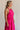 Side view of female model wearing the Luna Halter Tie Tiered Maxi Dress in Pink which features Lightweight Fabric, Tiered Body, Maxi Length, Thigh Length Lining, Halter Neckline with Tie and Open Back