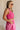 Side view of female model wearing the Cecilia Pink Smocked Midi Dress which features Pink Lightweight Fabric, Pink Lining, Pockets On Each Side, Midi Length, Textured Upper, Square Neckline and Sleeveless