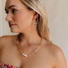 Front view of female model wearing the Brielle Pearl & Gold Chain Link Necklace which features one layer gold chain link with 3 cream pearl beads and adjustable clasp closure