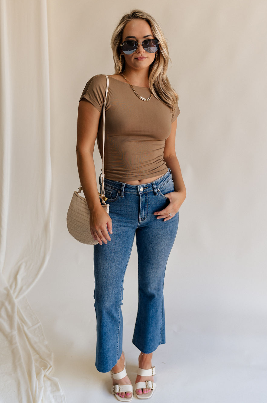 Full body view of female model wearing the Sloane Mocha Brown Open Back Top which features Mocha Brown Lightweight Fabric, Short Sleeves, Round Neckline and Scoop Back