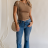 Full body view of female model wearing the Emerson Medium Wash Straight Leg Jeans which features Medium Wash Denim, Two Front Pockets, Two Back Pockets, Front Zipper with Button Closure, Belt Loops and Straight Pant Legs