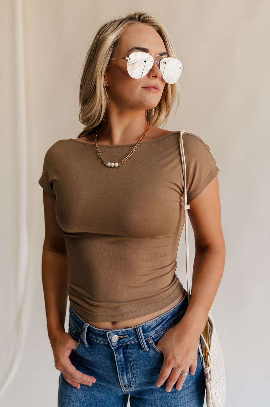 Front view of female model wearing the Sloane Mocha Brown Open Back Top which features Mocha Brown Lightweight Fabric, Short Sleeves, Round Neckline and Scoop Back