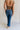 Back view of female model wearing the Emerson Medium Wash Straight Leg Jeans which features Medium Wash Denim, Two Front Pockets, Two Back Pockets, Front Zipper with Button Closure, Belt Loops and Straight Pant Legs