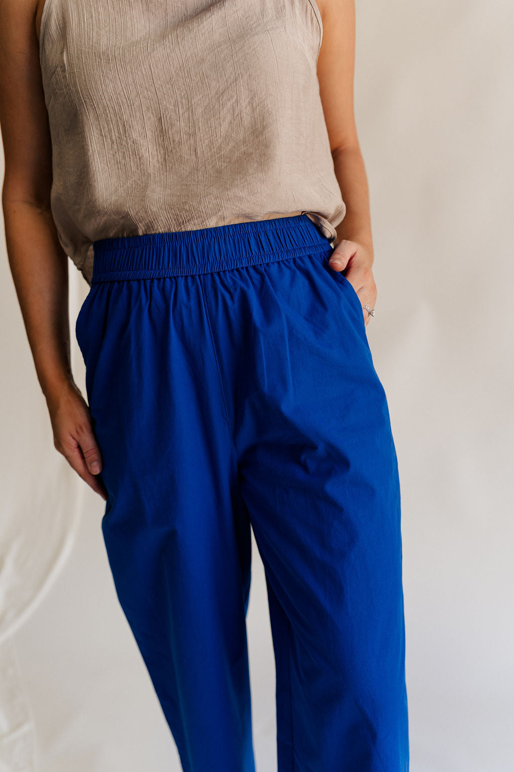 Close up view of female model wearing the Freya Cobalt Blue Straight Leg Pants which features Cobalt Blue Cotton Fabric, Wide Pant Legs, Elastic Waistband and Two Side Pockets