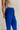 Side view of female model wearing the Freya Cobalt Blue Straight Leg Pants which features Cobalt Blue Cotton Fabric, Wide Pant Legs, Elastic Waistband and Two Side Pockets