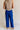 Full body back view of female model wearing the Freya Cobalt Blue Straight Leg Pants which features Cobalt Blue Cotton Fabric, Wide Pant Legs, Elastic Waistband and Two Side Pockets