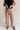 Front view of female model wearing the Lena Light Taupe Wide Cropped Leg Pants which features Light Taupe Denim Fabric, Wide Pant Leg, Raw Hem, Front Zipper with Button Closure, Two Front Pockets, Two Back Pockets and Belt Loops