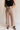 Front view of female model wearing the Lena Light Taupe Wide Cropped Leg Pants which features Light Taupe Denim Fabric, Wide Pant Leg, Raw Hem, Front Zipper with Button Closure, Two Front Pockets, Two Back Pockets and Belt Loops