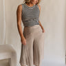 Full body view of female model wearing the Sienna Light Taupe Cropped Flare Pants which features Lightweight Taupe Fabric, Taupe Lining, Cropped Wide Pant Legs, Pockets on each side and Back Elastic Waistband
