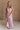Full body front view of female model wearing the Imani Lavender Maxi Dress that has lavender fabric, thin straps, and a ruffled maxi hem.