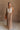 Full body front view of female model wearing the Bristol Mocha & Tan Maxi Dress that has a tan knit upper with thick straps, a mocha maxi skirt, and a drawstring waist. 